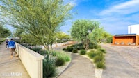 an artist's rendering of a walkway with trees and shrubs